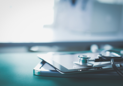 Medical equipment: blue stethoscope and tablet on white background. Medical equipment